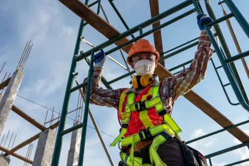 Site safety professional in New York working on scaffolding.