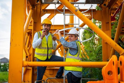 two-men-in-yellow-vests-are-working-on-a-construct-2024-07-23-19-28-53-utc